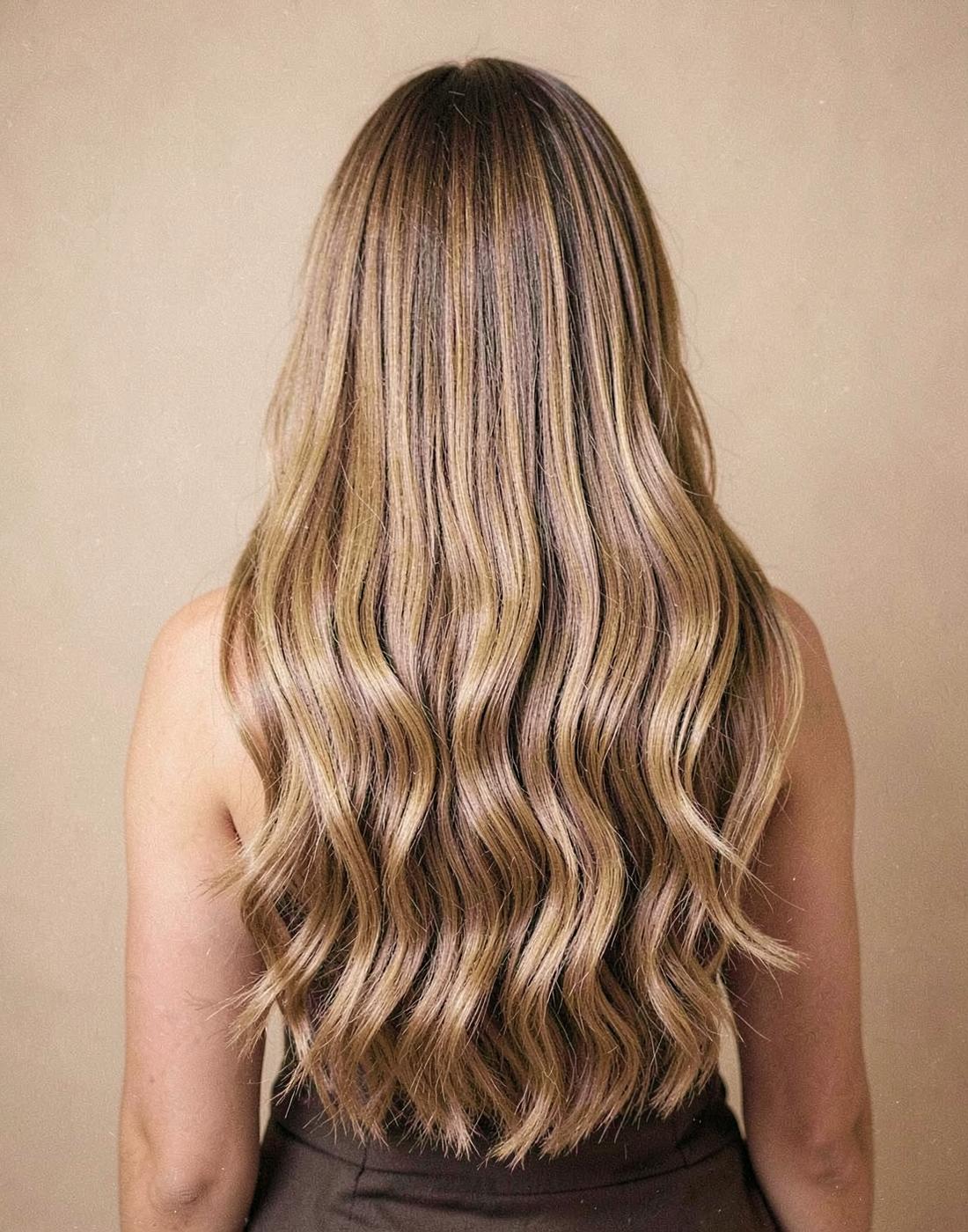 Blended tape-in extensions for length and fullness by Niki Ruscio.